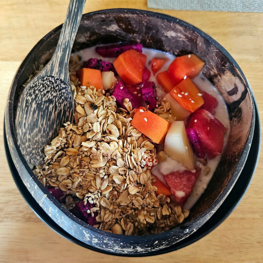 Vegan breakfast in Koh Phangan, Thailand: Coconut yogurt with granola and tropical fruit at Seaflower Bungalows